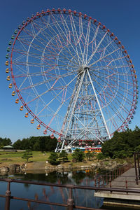 Low angle view of ferris wheel against sky