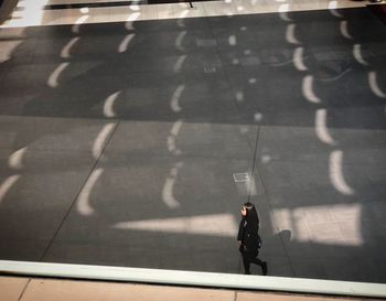 High angle view of man walking on road