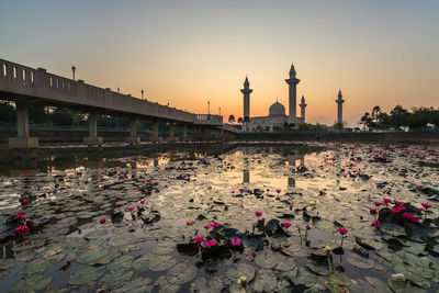 View of people on bridge against sky during sunset