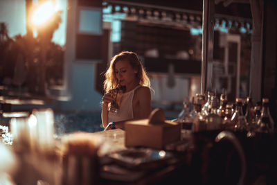 Young woman having drink at restaurant