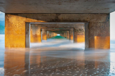 Reflection of building on wet pier