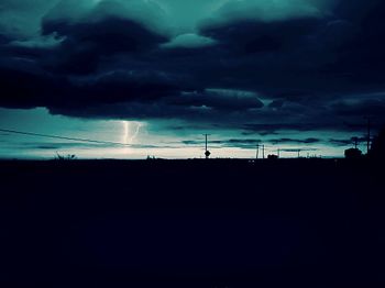 Silhouette of landscape against cloudy sky