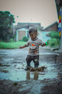 Portrait of boy playing with water