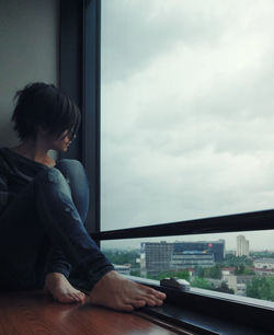 Man looking through train window