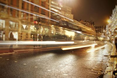 Light trails on city street during rainy season