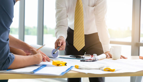 Midsection of business colleagues working at office