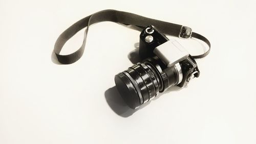 Close-up of camera over white background