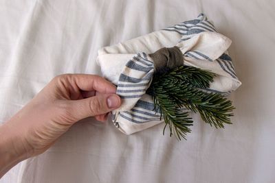 Cropped hand of person holding gift