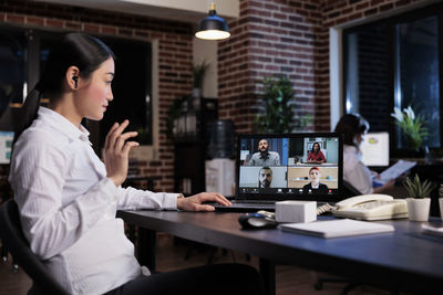 Businesswoman using laptop at office