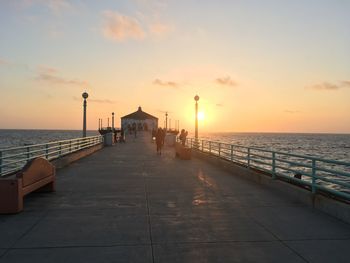 Pier on sea during sunset