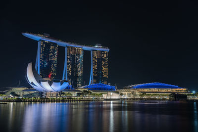 Illuminated modern building against sky at night