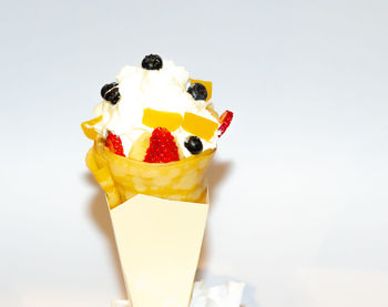 Close-up of ice cream cone against white background