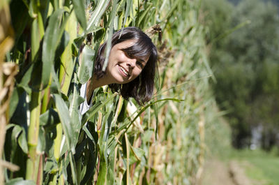 Close-up portrait of young woman in field