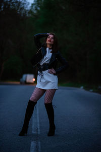 Full length of woman standing on road