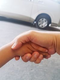 Cropped hands of mother and son