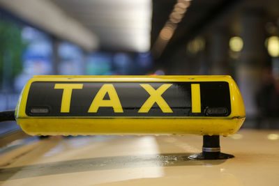 Close-up of yellow sign on car