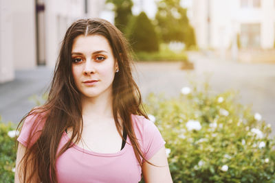 Portrait of beautiful young woman standing outdoors