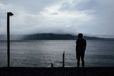 Rear view of man looking at sea