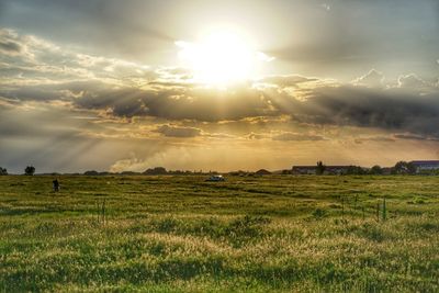 Scenic view of field against sky during sunset