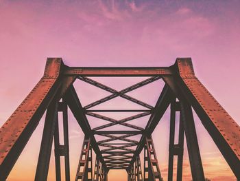 Low angle view of bridge against sky during sunset