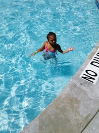 High angle view of girl swimming in pool