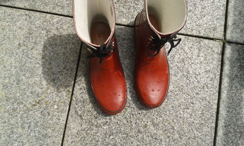 High angle view of wet boots on floor