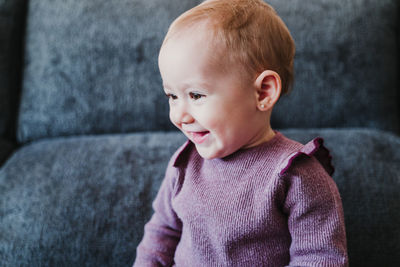 Portrait of cute boy looking away at home