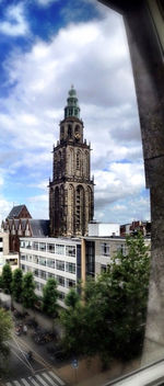 Buildings against cloudy sky