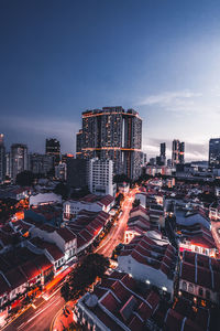 High angle view of traffic on road by buildings against sky