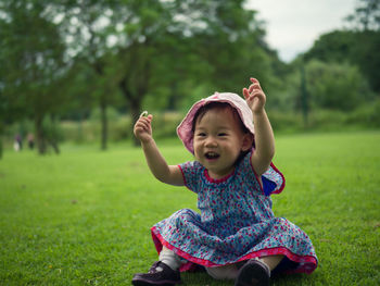 Portrait of smiling girl playing on field