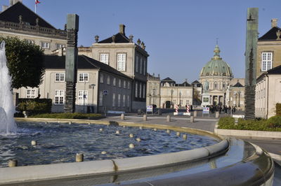 View of buildings in city against clear sky