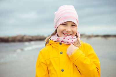 Portrait of smiling girl standing at beach