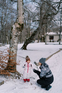 Full length of boy standing on snow