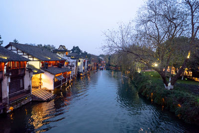 River amidst buildings against sky