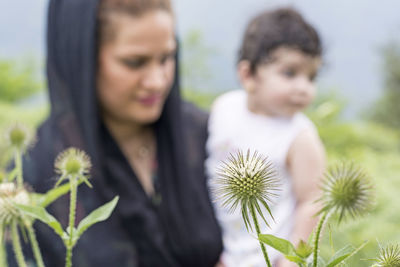 Rear view of people on flowering plant