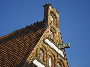 Low angle view of temple against clear blue sky