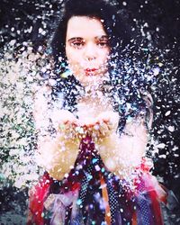 Portrait of smiling young woman in water