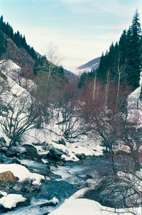 Scenic view of river against sky during winter