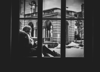 Woman looking through window