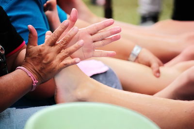 Close-up of people with hands