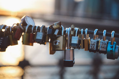 Close-up of love locks hanging on railing at brooklyn bridge