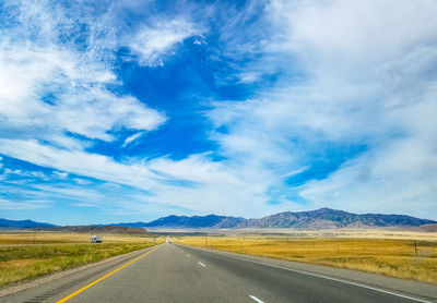 Empty road along countryside landscape