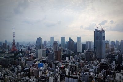 Tokyo cityscape against cloudy sky