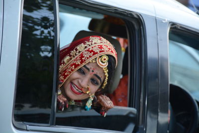 Bride crying while looking away in car