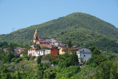 Houses in town against clear sky