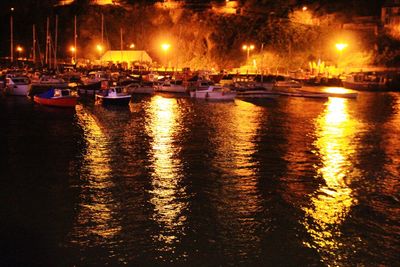 Boats in sea at night