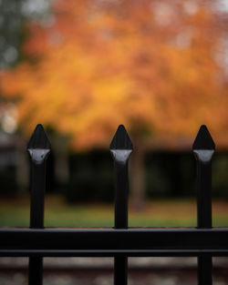 Close-up of railing against orange sky