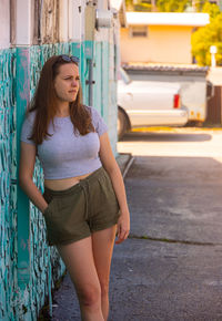 Portrait of young woman standing on street