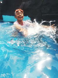 Portrait of a smiling woman swimming in pool