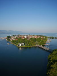 High angle view of river and cityscape against clear sky